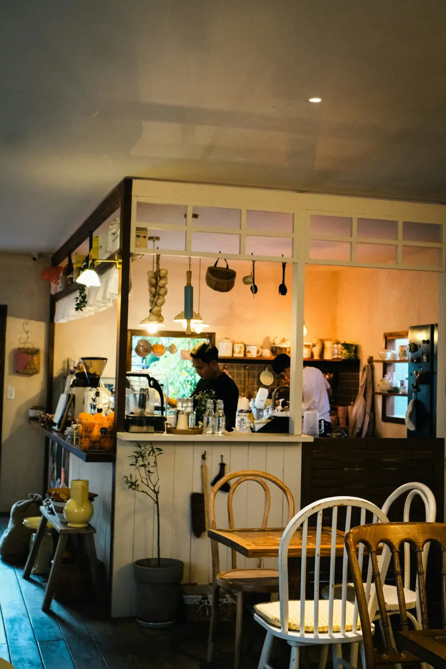 A cozy restaurant interior with someone behind the counter