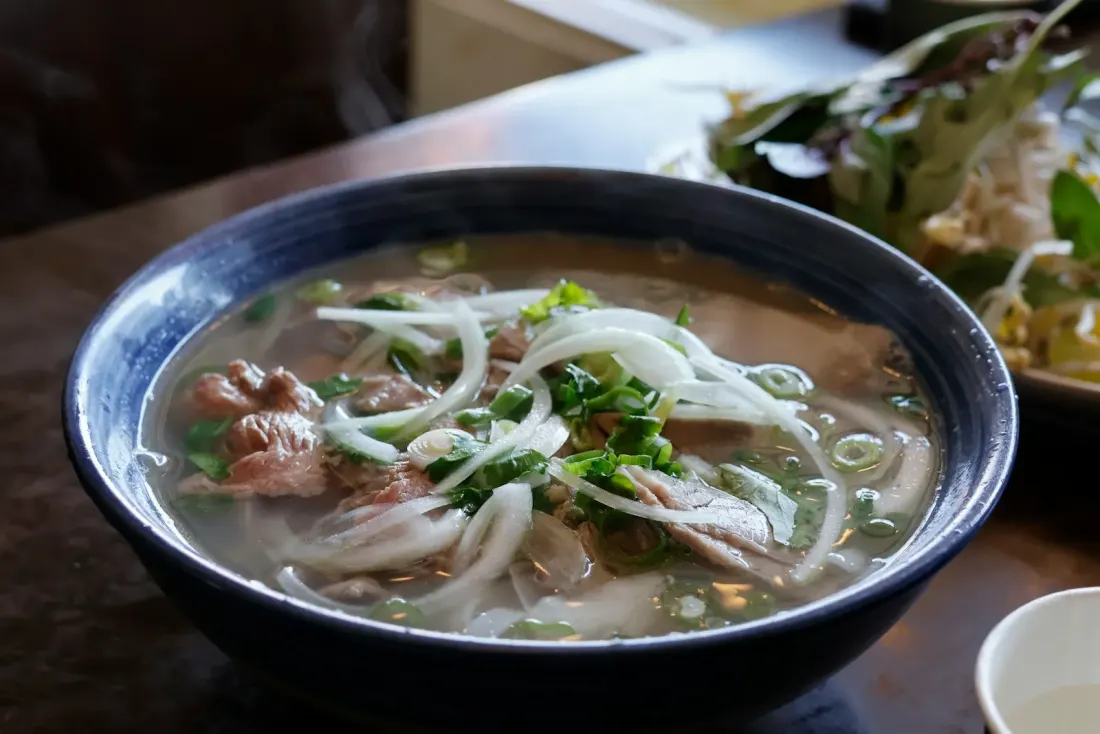 A bowl of Vietnamese noodle soup with beef